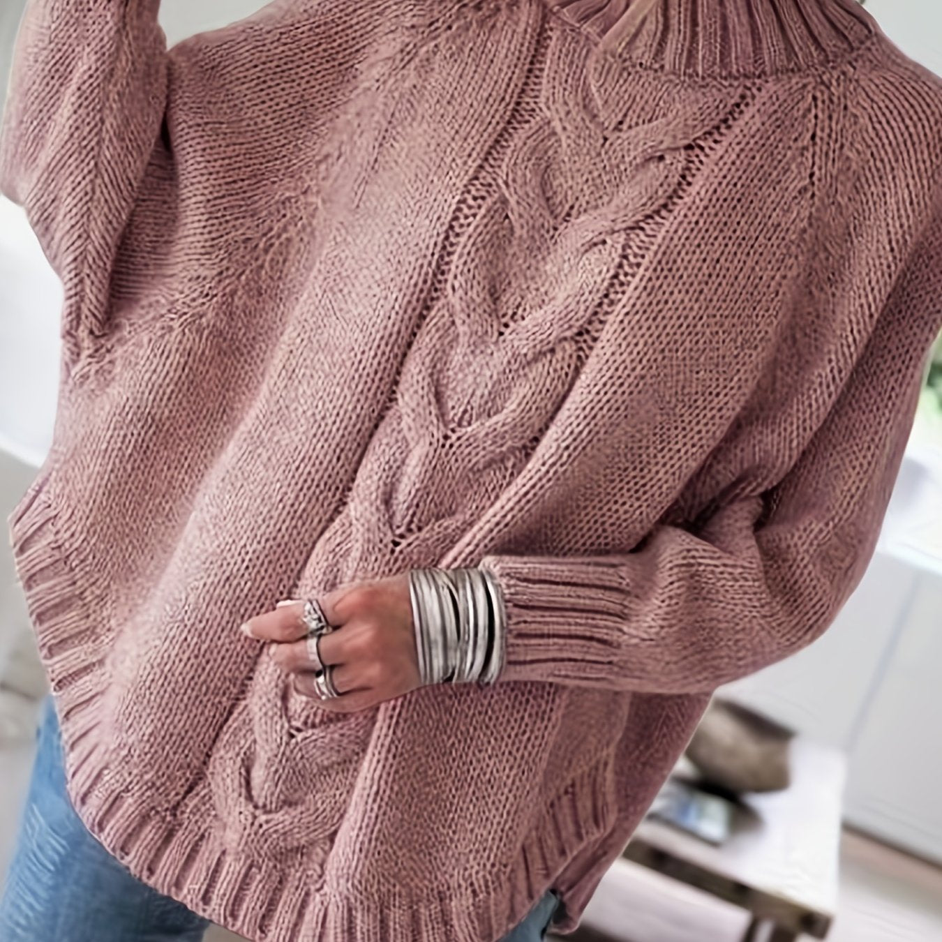 Vintage-inspired cable knit sweater with wide hem
