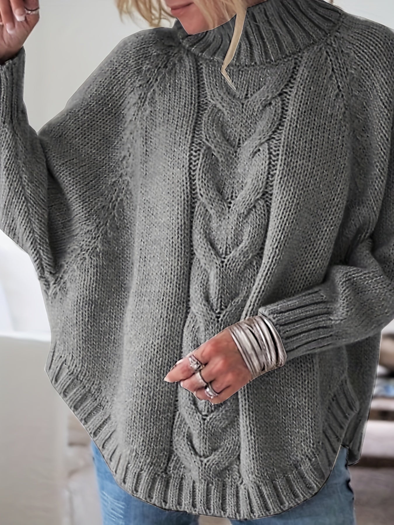 Vintage-inspired cable knit sweater with wide hem