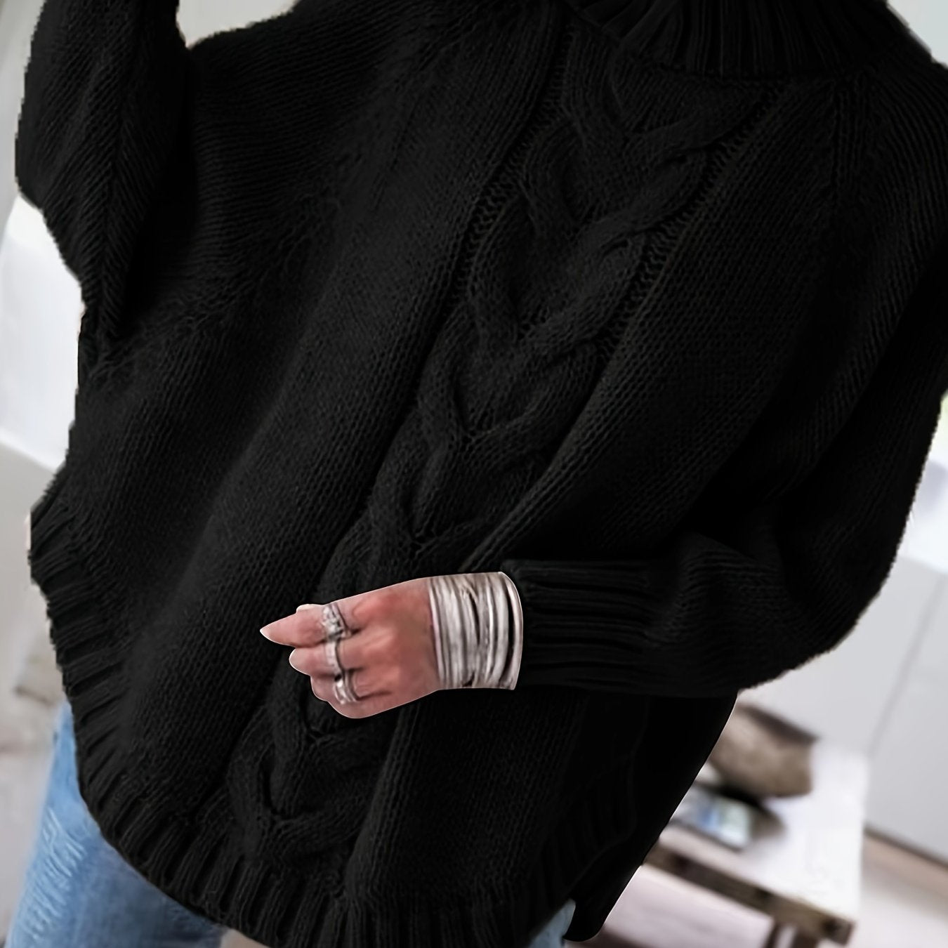 Vintage-inspired cable knit sweater with wide hem