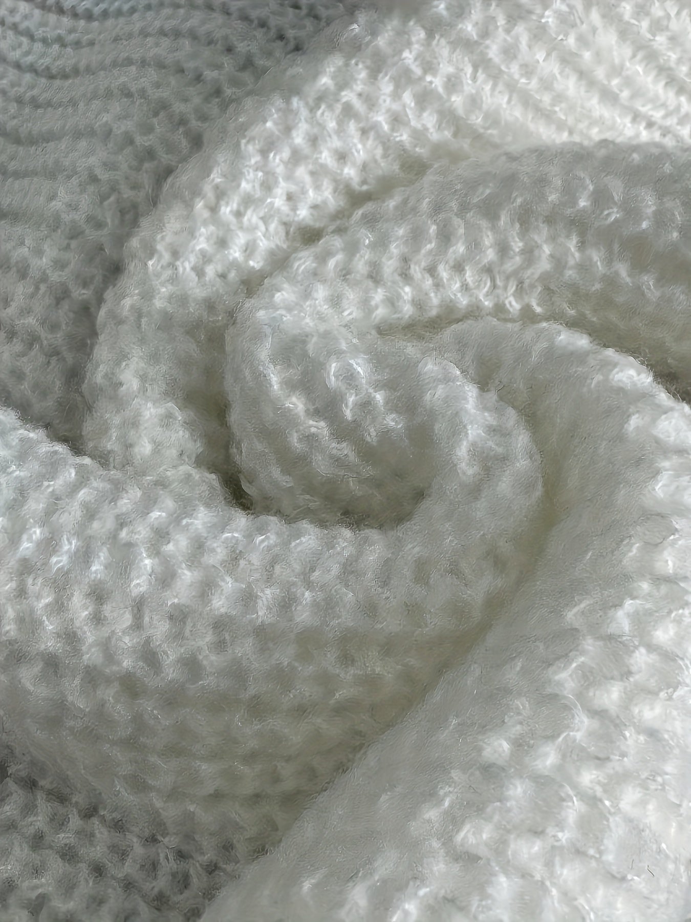 Oversized turtleneck, relaxed fit, and decorative button detail.