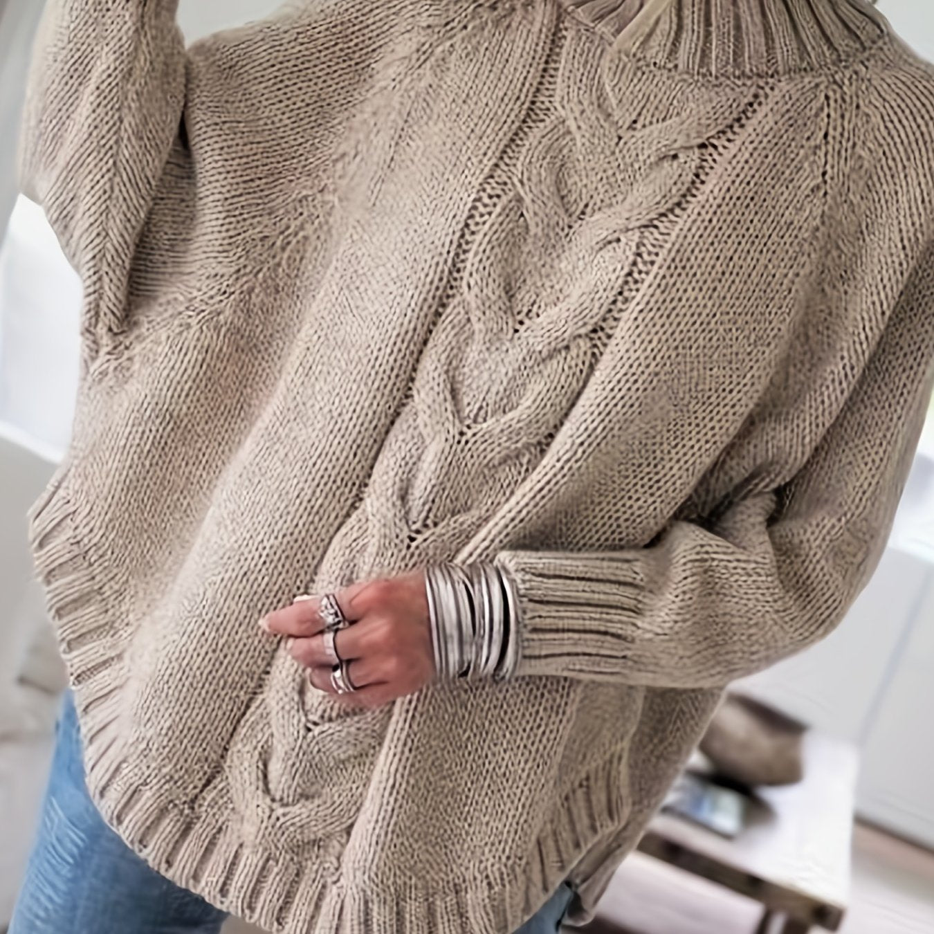 Vintage-inspired cable knit sweater with wide hem