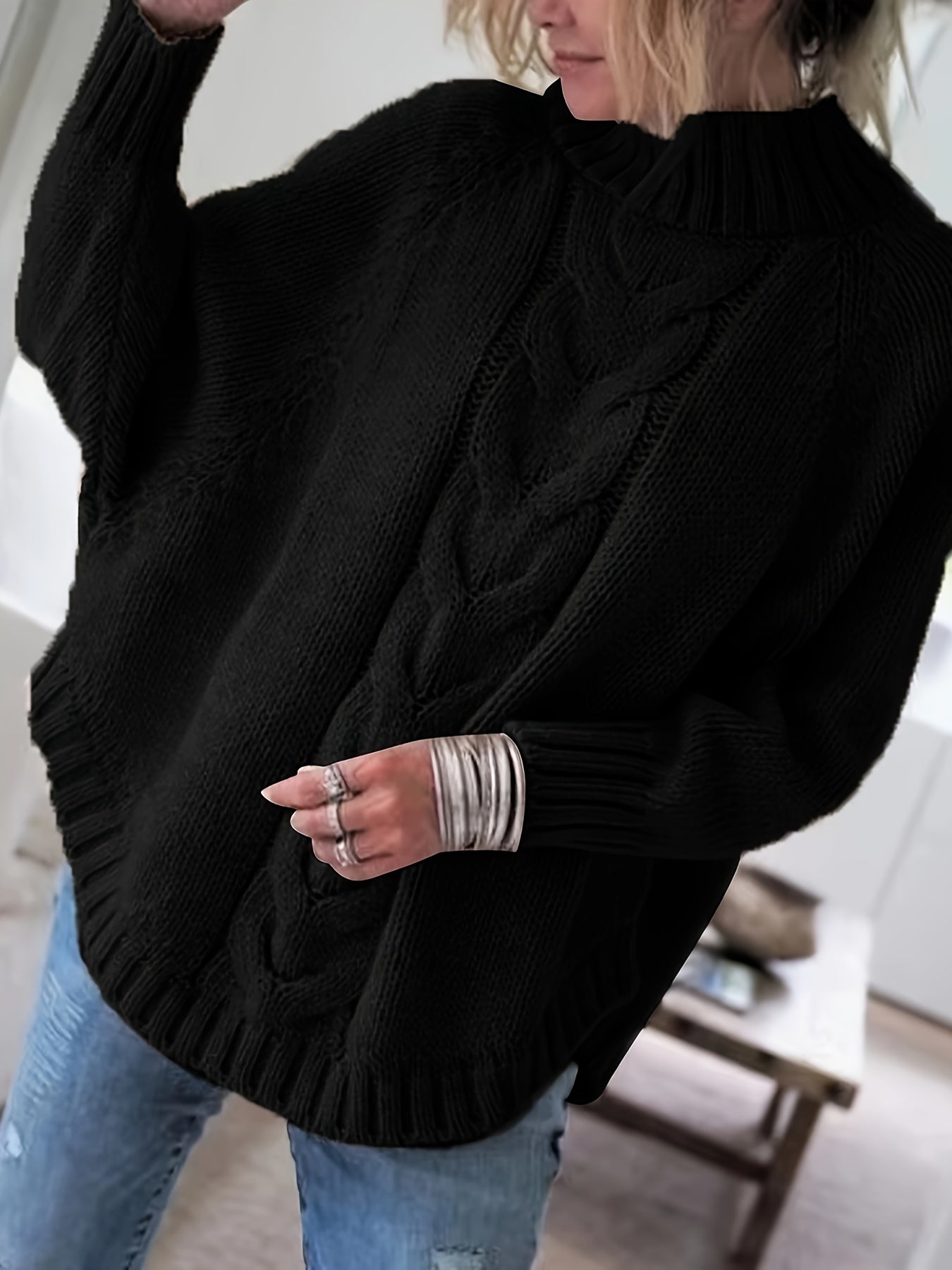 Vintage-inspired cable knit sweater with wide hem