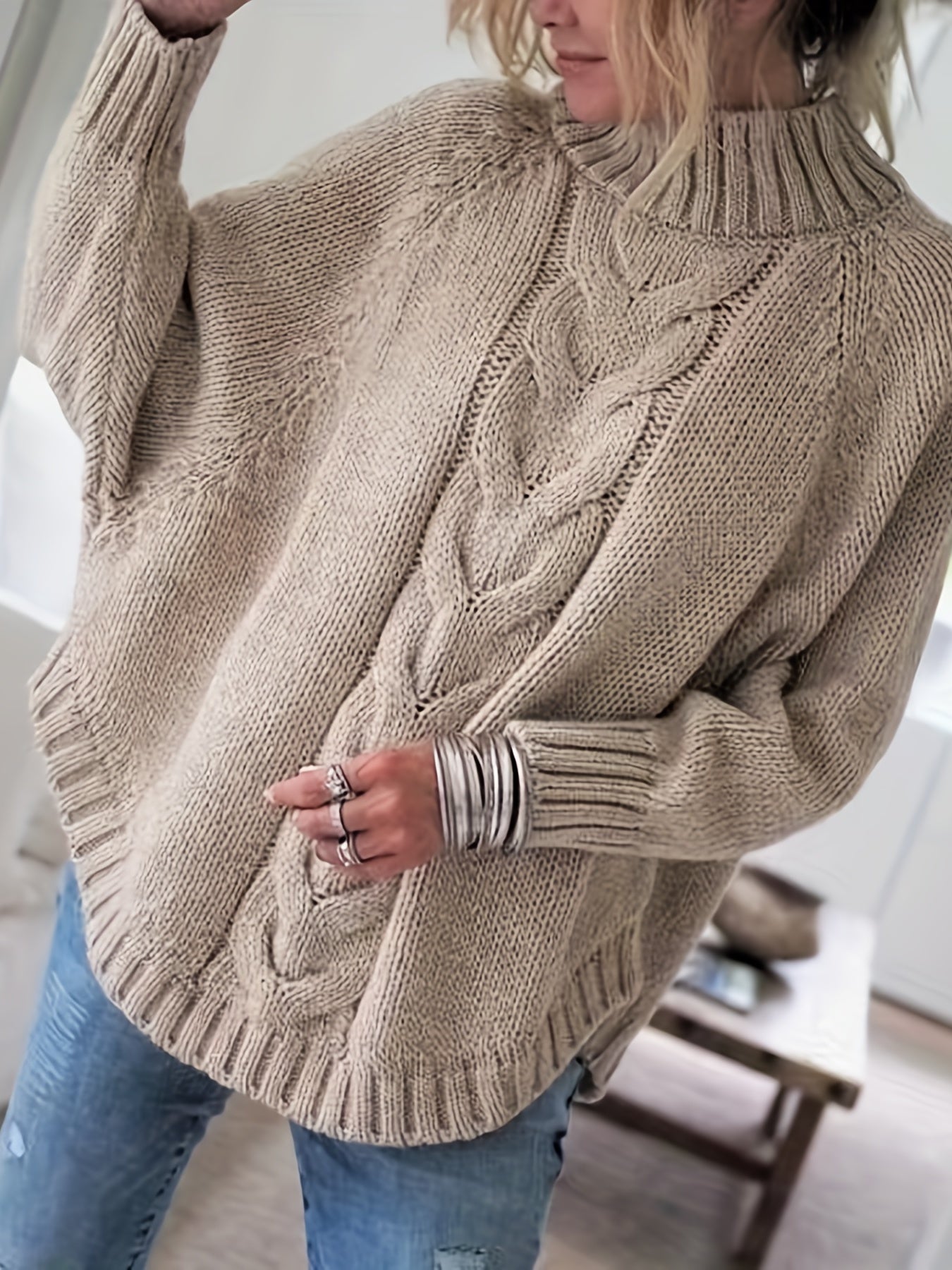 Vintage-inspired cable knit sweater with wide hem